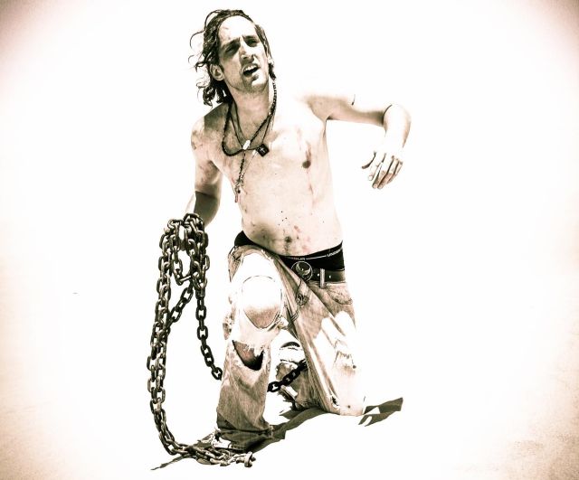 Mike Cavallo carrying the chains of addiction for an album photoshoot
