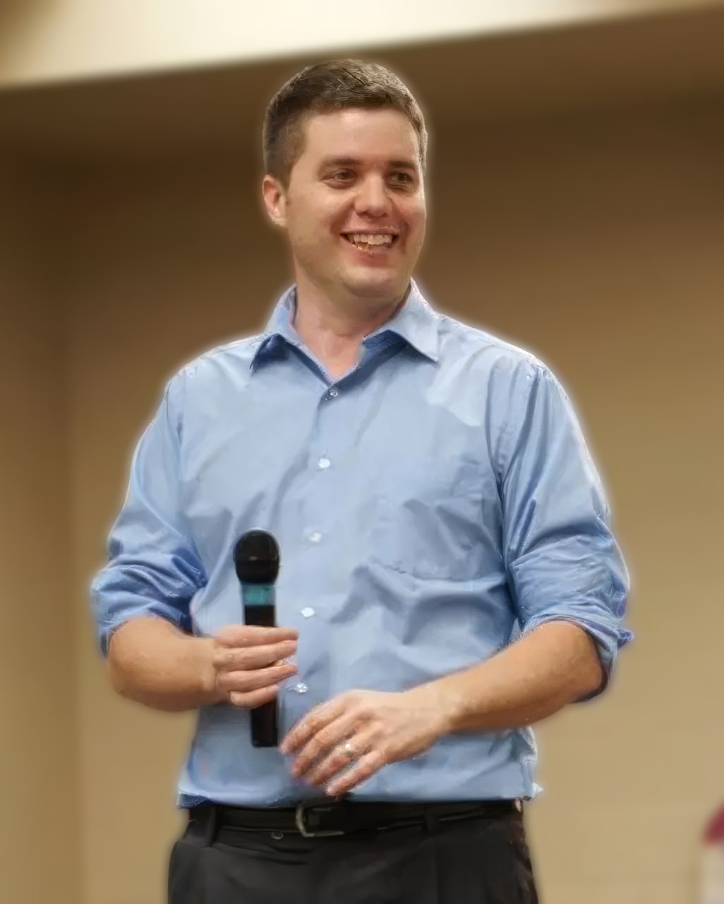 Matt Cavallo speaking on stage with a microphone