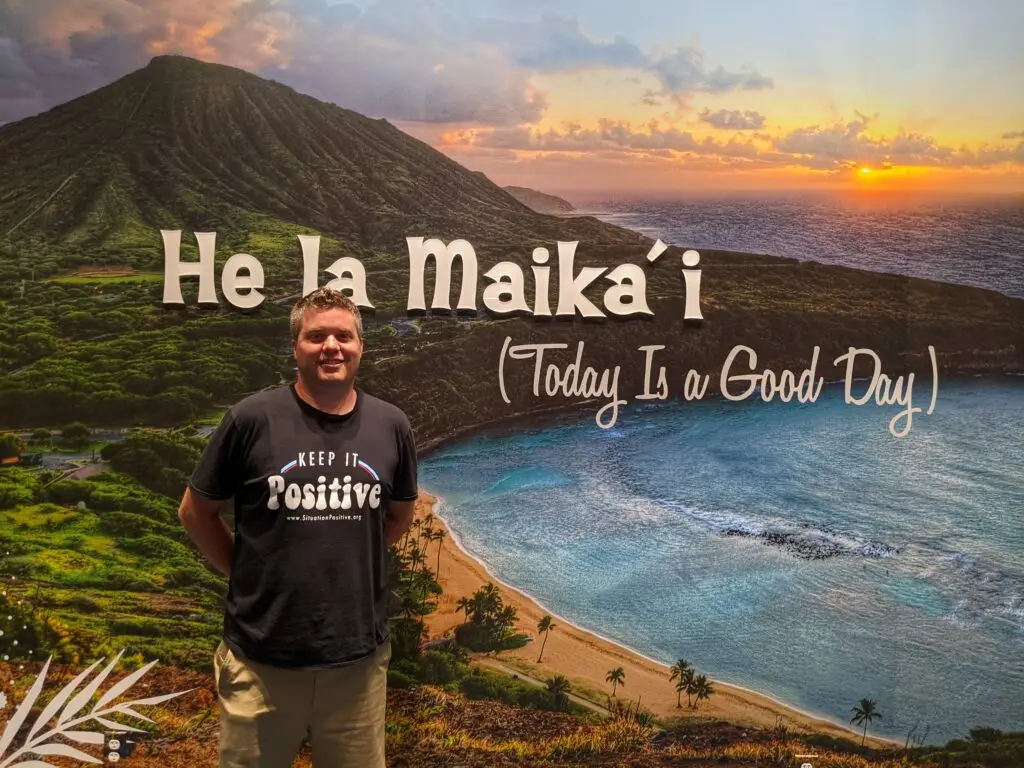 Matt Cavallo standing in front of a painting of Hawaii