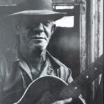 Joe Cavallo strumming a guitar.