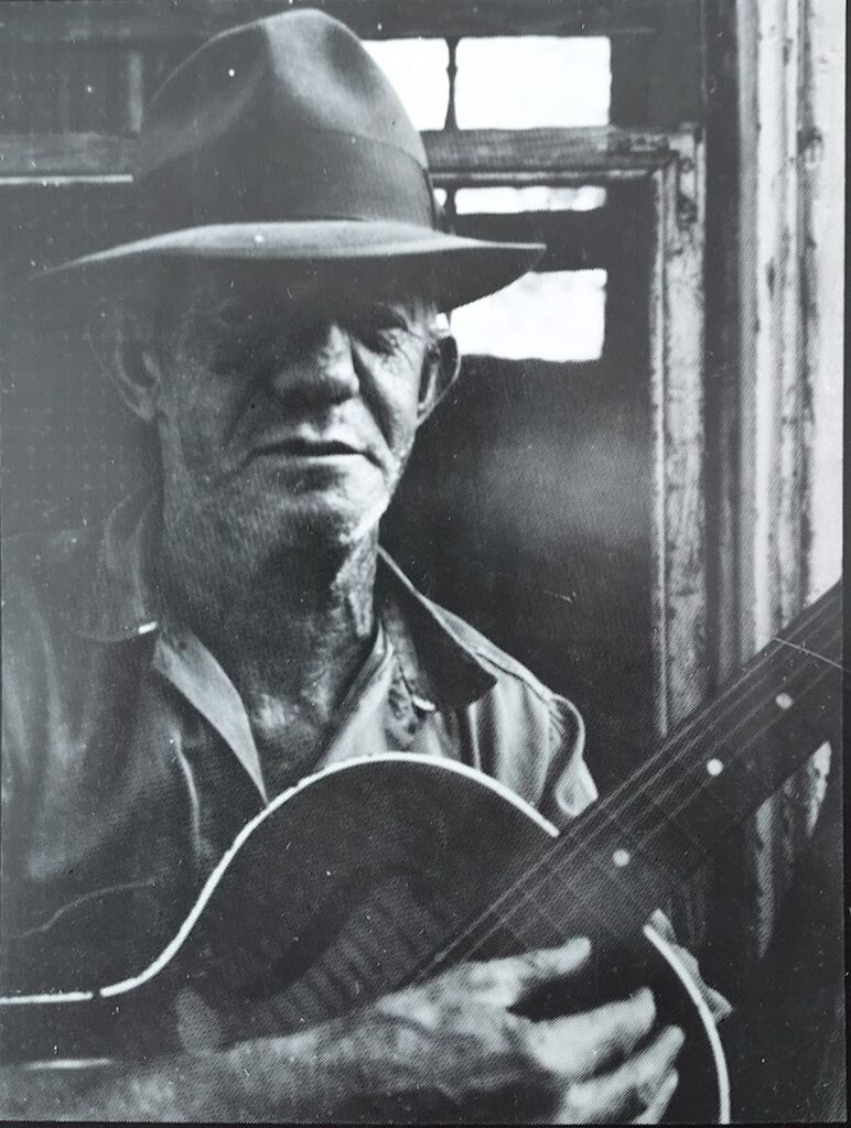 Joe Cavallo strumming a guitar.